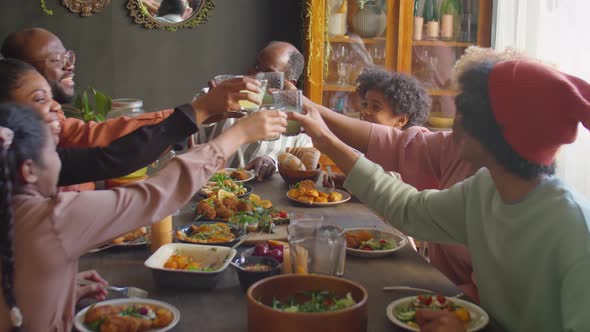 African American Family Toasting at Home Holiday Dinner