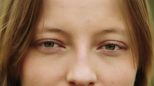 Natural Beauty Concept. Close Up Shot of Caucasian Woman with Beautiful Green Eyes and Frekles