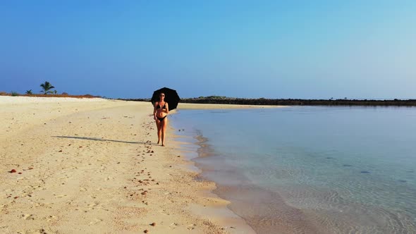 Women best friends on beautiful coastline beach vacation by transparent sea with white sandy backgro