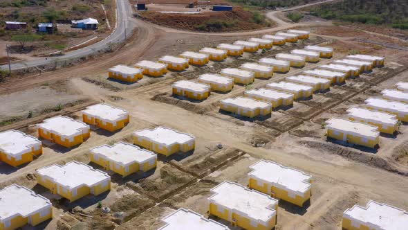 Aerial View of Many Rows of Bright Yellow and Glowing White Rooftops Workers Homes for Dominican Rep