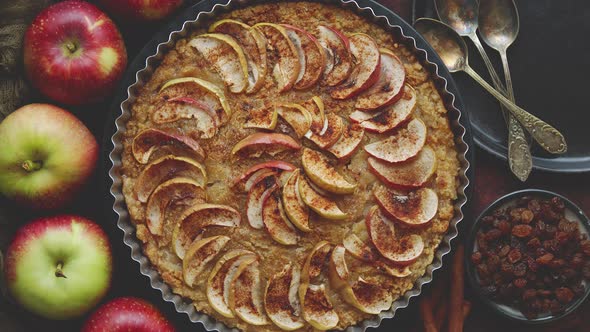 Homemade Apple Tart Pie with Fresh Fruits and Cinnamon Sticks on Rusty Background