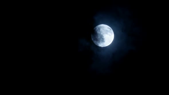 Clouds Move Back Revealing A Large Full Moon