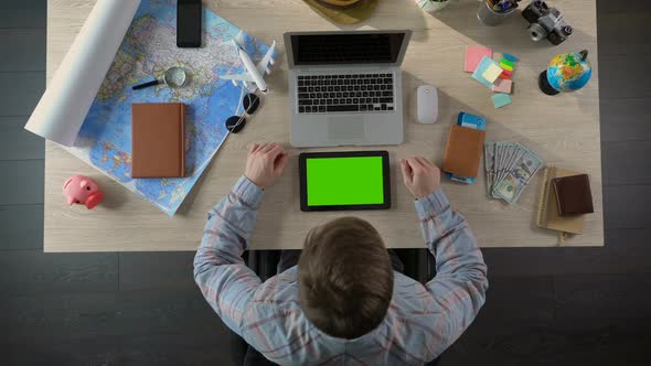 Man Looking for Hotel Room in Mobile Application on Tablet With Green Screen