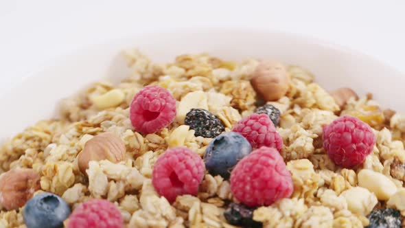 Milk Flowing Into the Bowl with Healthy Muesli