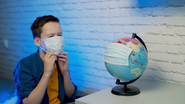 Boy looking at globe learning about virus spreading around the world