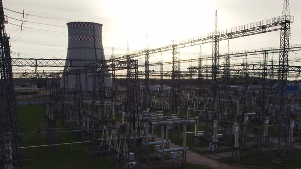 Transformation station and electric power plant with tall pylons and voltage distribution cables.