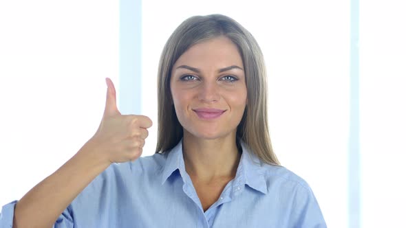 Portrait of Positive Young Woman Gesturing Thumbs Up