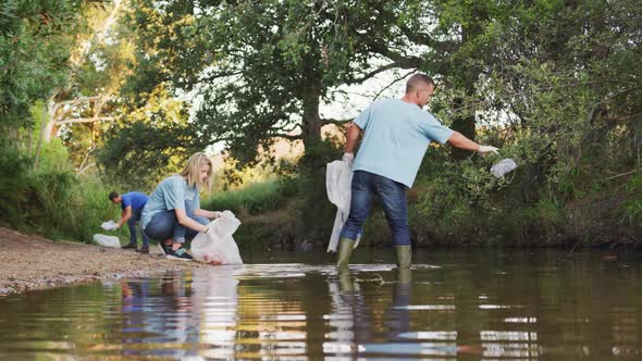 People cleaning the river in a forest