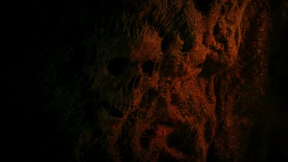 Skull In Cave Wall Lit Up In Fire Light