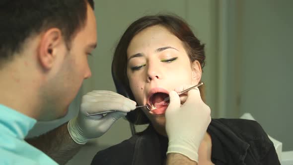 male dental surgeon examining a little girl alt