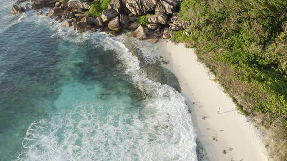 Aerial view of a person walking on the beach of Anse Lazio, Seychelles.