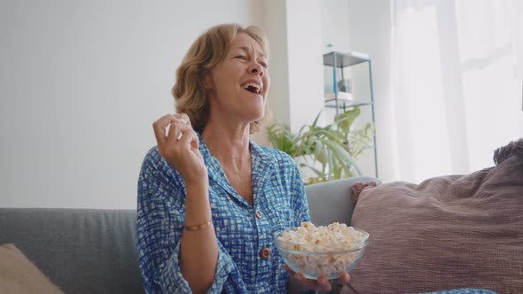 woman enjoying a tv series on the couch