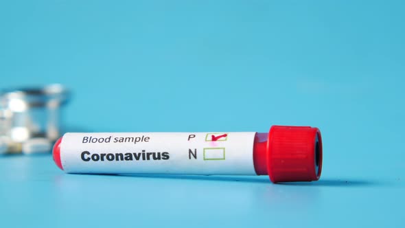 Close Up of Corona Virus Blood Test Tube on Blue Background