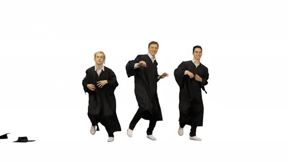 Three Happy Male Graduates Throwing Mortarboards in the Air and Starting Dancing in Synch on White
