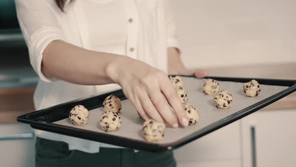 Woman Puts on Baking Tray Raw Cookies Before Baking