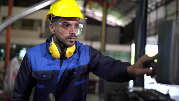 Factory Worker is Setting Up CNC Lathe Machine