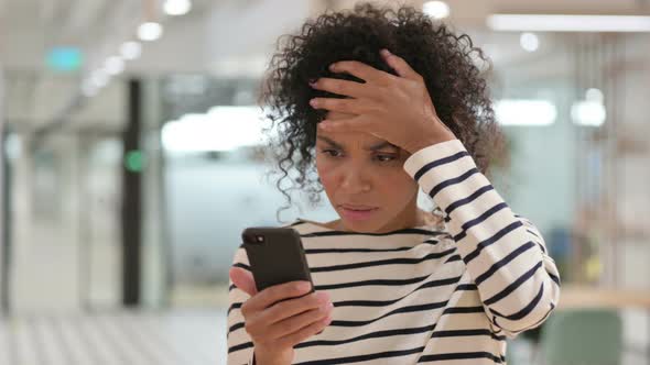 African Woman Having Loss on Smartphone