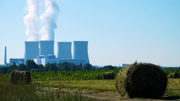 Field with Plants (Haystacks) - Factory (Nuclear Power Station) - Smoke From Chimney in Background