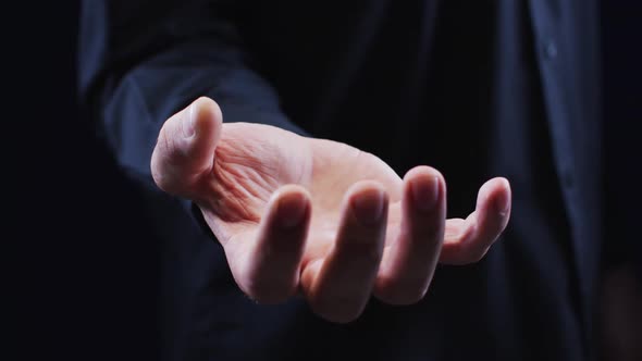 Hand of a caucasian man palm up holding an unseen object