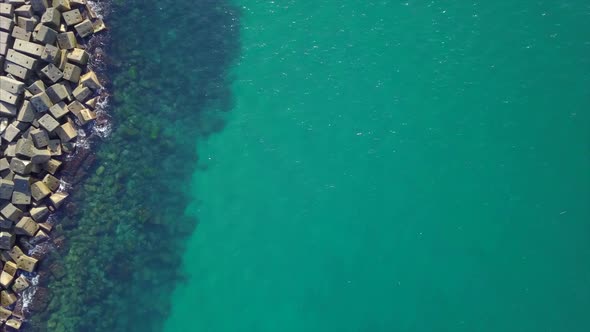 Aerial View Of Breakwater Stone Pier And Lighthouse