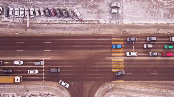 Aerial top view of crossroad intersection with busy urban traffic