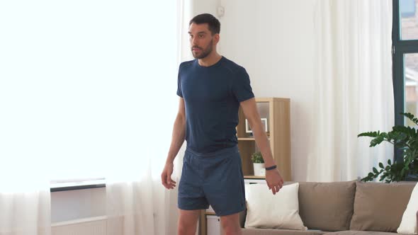 Man Exercising and Doing Squats at Home 