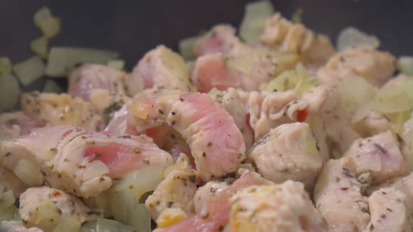 Turkey Meat Cut Into Pieces in a Frying Pan