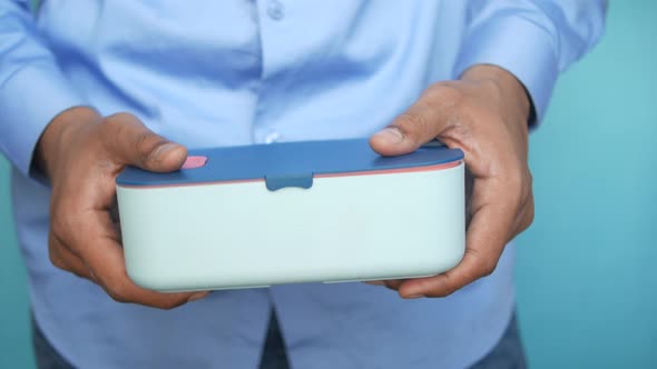 Men Holding a Lunch Box Close Up