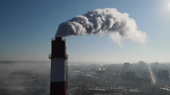 Aerial drone view of industrial smoke coming from pipe factory tube. City pollution idea