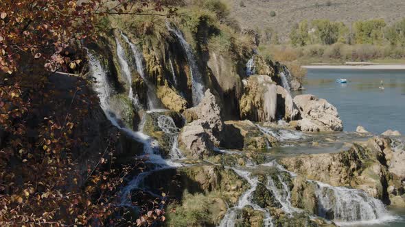 Fall Creek Falls along the Snake river with people floating the river