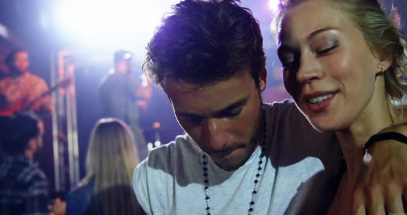 Couple dancing with a mug of beer at a concert 4k