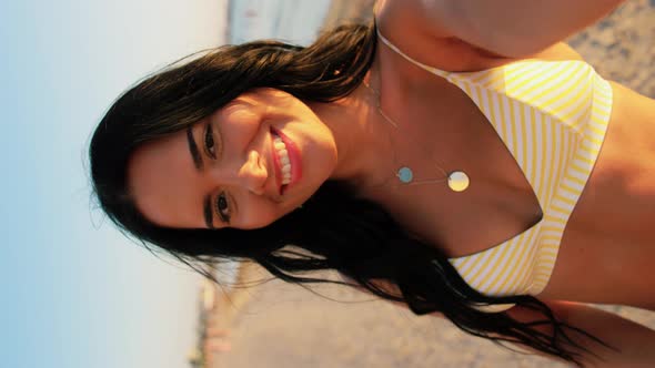 Smiling Woman in Bikini Taking Selfie on Beach