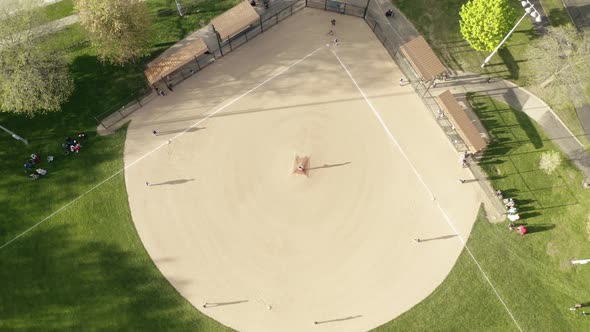 Aerial Drone View of Kids Play Baseball Field at Park on Sunny Day