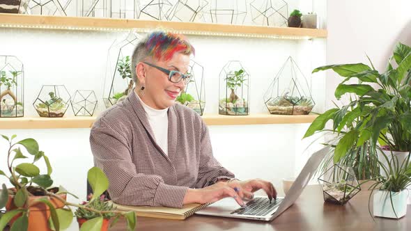 Portrait of Openminded Business Lady with Glasses Smile While Sitting on Table with Notebooks and