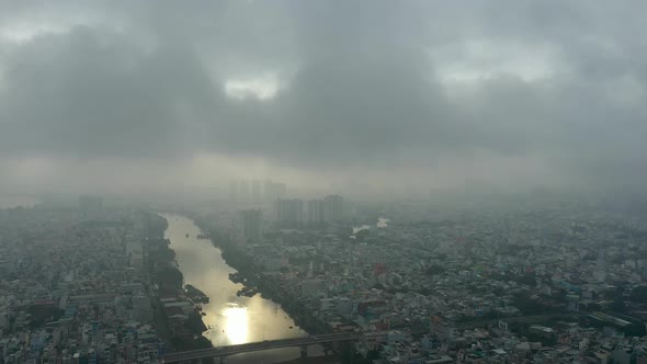 Saigon, Ho Chi Minh City, Vietnam early morning drone footage flying a big orbit around canal over d