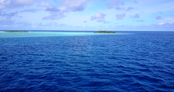 Wide angle above tourism shot of a paradise sunny white sand beach and aqua blue ocean background