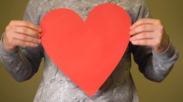 Man Holding Big Red Heart on His Chest