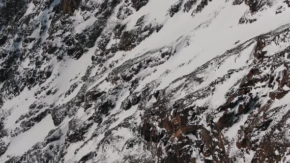 Steep Slopes of Old Mountains with White Snow on Frosty Day