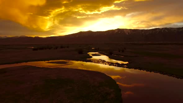 Flying over river at golden sunrise