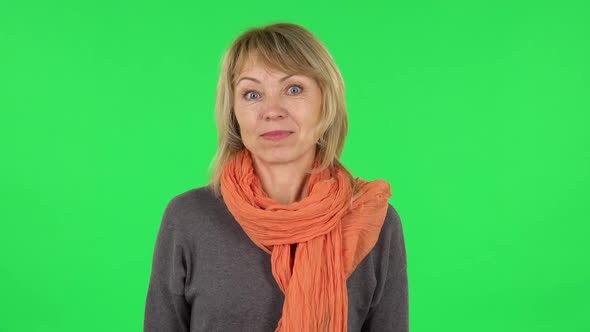 Portrait of Middle Aged Blonde Woman with Shocked Wow Face Expression. Green Screen