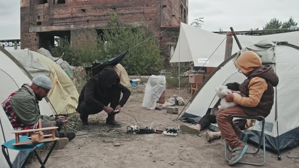 Refugees Charging Mobile Phones at Tent City