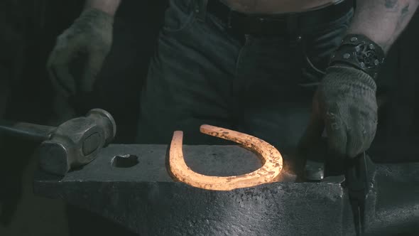 The Blacksmith Gets a Horseshoe From the Fire and Works on It