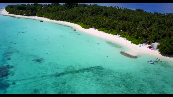 Aerial drone seascape of marine lagoon beach break by blue green lagoon and white sandy background o