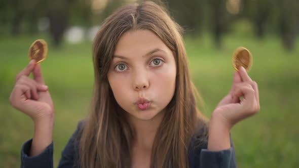 Front View Cute Cheerful Teenage Girl Grimacing Covering Eyes with Dried Lemon Smiling Looking at