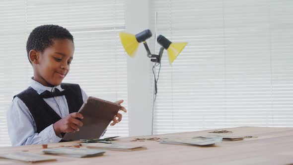 Kid as business executive using digital tablet 4k