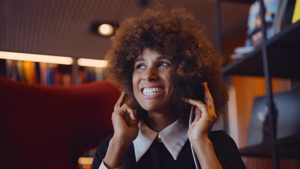 Woman Smiling To Music Through Headphones