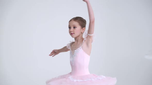 Young Female and Little Girl in a White Tutu Dance Ballet and Perform Choreographic Elements on a