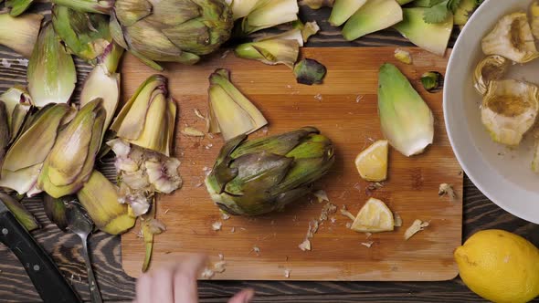 Woman Cleaning Artichokes