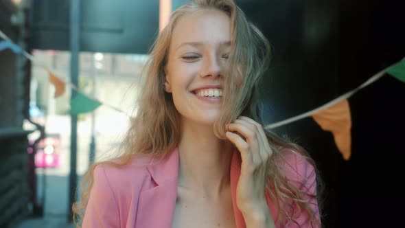 Slow Motion Portrait of Joyful Female Student Laughing and Looking at Camera Standing Outside in