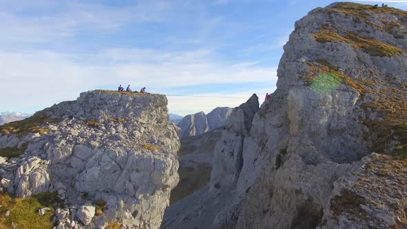 Aerial view of a man balancing while slacklining on a tightrope in the mountains.